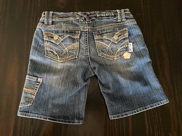 Ladies Shorts with a blue pocket and beige flower patch. Size 9/10